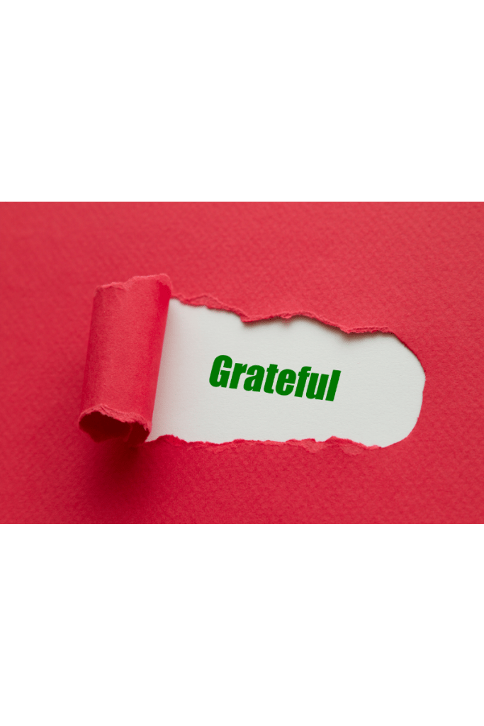 Page with a section ripped back and the word grateful showing underneath